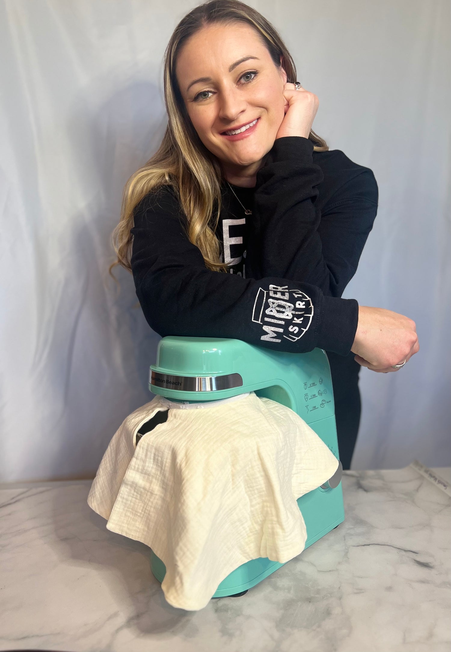 Image of Casey Macalush creator and owner of Mixer Skirt with hamilton beach stand mixer with mixer skirt fabric splash guard